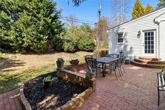 view of patio with entry steps and outdoor dining area