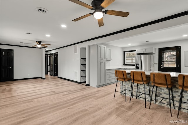 interior space featuring stainless steel fridge, visible vents, light countertops, and gray cabinetry