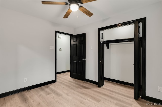 unfurnished bedroom featuring light wood-style flooring, baseboards, ceiling fan, and a closet