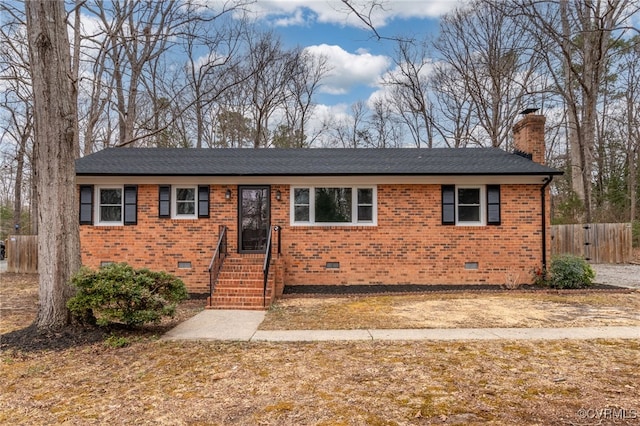 ranch-style home featuring brick siding, crawl space, a chimney, and fence