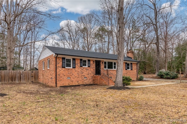 ranch-style home with crawl space, a chimney, fence, and brick siding