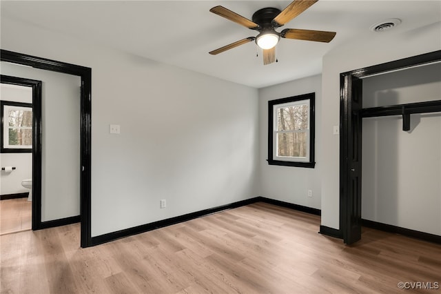 unfurnished bedroom with a ceiling fan, visible vents, baseboards, a closet, and light wood-type flooring