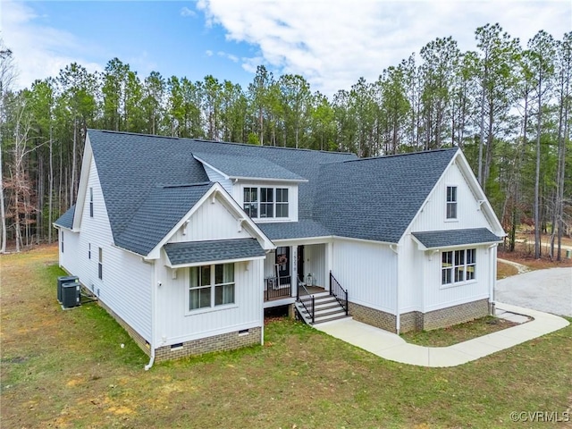 modern farmhouse style home with crawl space, cooling unit, a shingled roof, and a front lawn