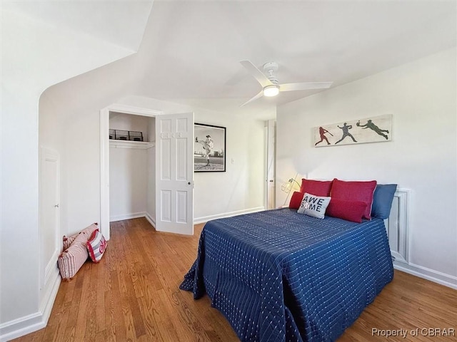 bedroom with a closet, baseboards, and wood finished floors