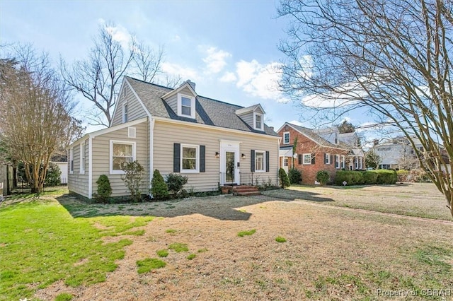 cape cod home with a front yard