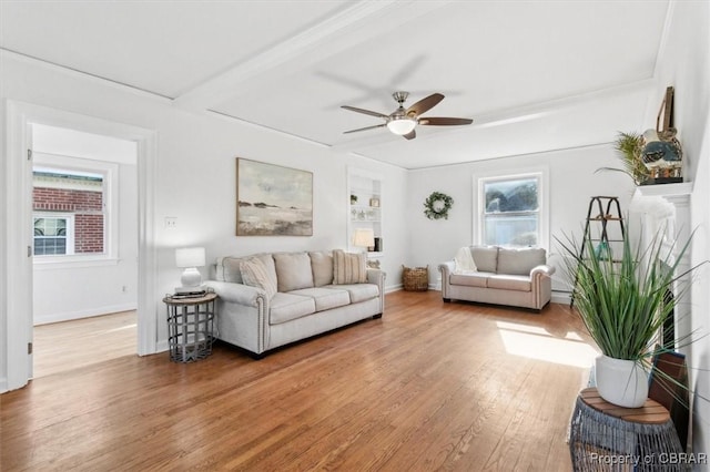 living room with ceiling fan, wood finished floors, and baseboards