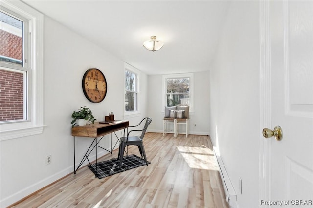 office space with light wood-style flooring and baseboards