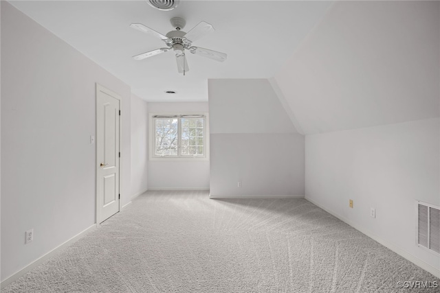 bonus room featuring visible vents, carpet flooring, vaulted ceiling, ceiling fan, and baseboards