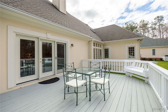 wooden deck featuring outdoor dining area