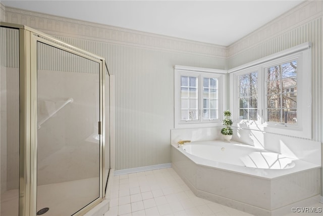 full bath featuring a stall shower, plenty of natural light, a bath, and baseboards