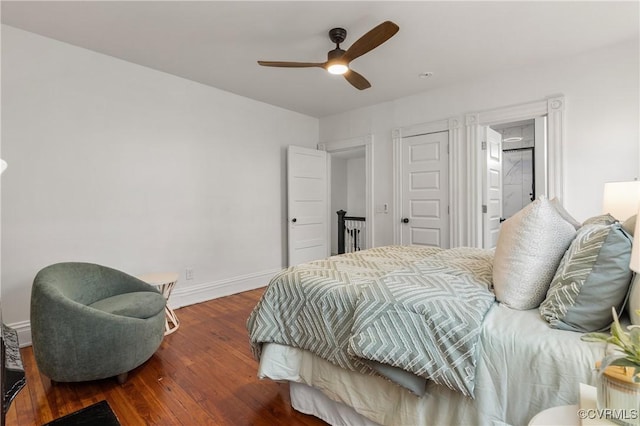 bedroom with ceiling fan, baseboards, and wood finished floors