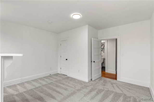 unfurnished bedroom with carpet flooring and baseboards