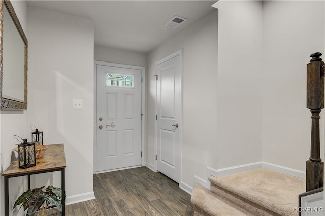 entrance foyer featuring dark wood-style flooring, visible vents, and baseboards