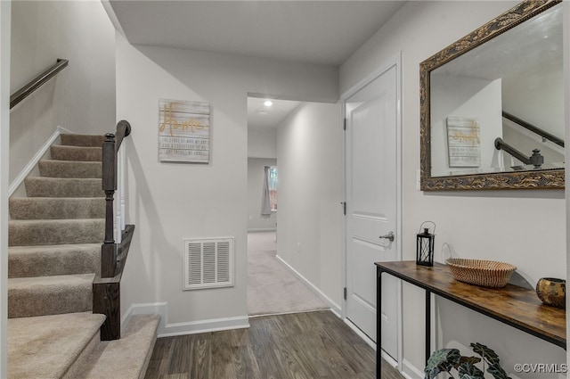 interior space with wood finished floors, visible vents, and baseboards