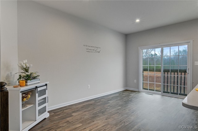 spare room with recessed lighting, dark wood-style flooring, and baseboards