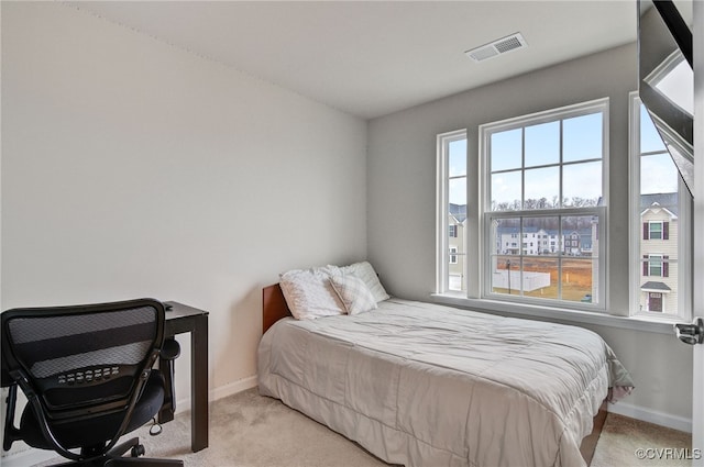 bedroom with light carpet, baseboards, and visible vents