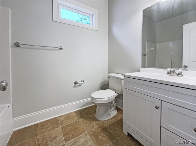 full bathroom featuring a shower, vanity, toilet, and baseboards