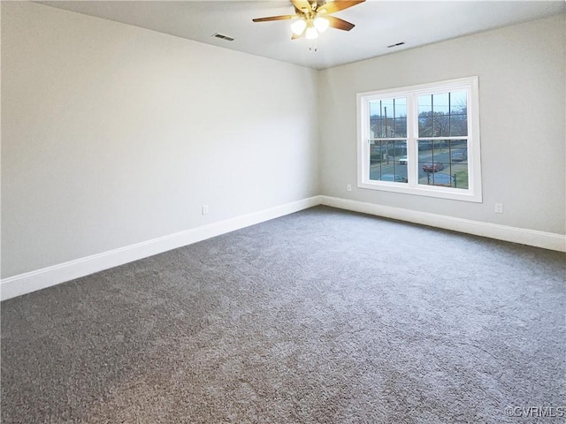 carpeted empty room featuring ceiling fan, visible vents, and baseboards