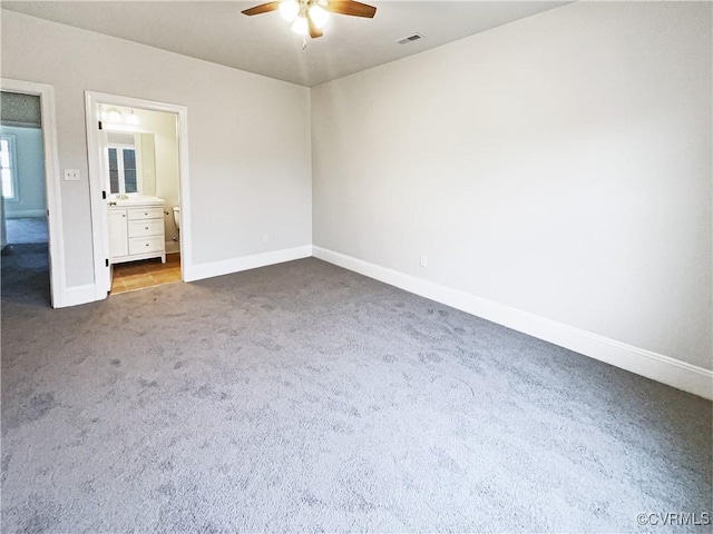 unfurnished bedroom with carpet, visible vents, a ceiling fan, connected bathroom, and baseboards