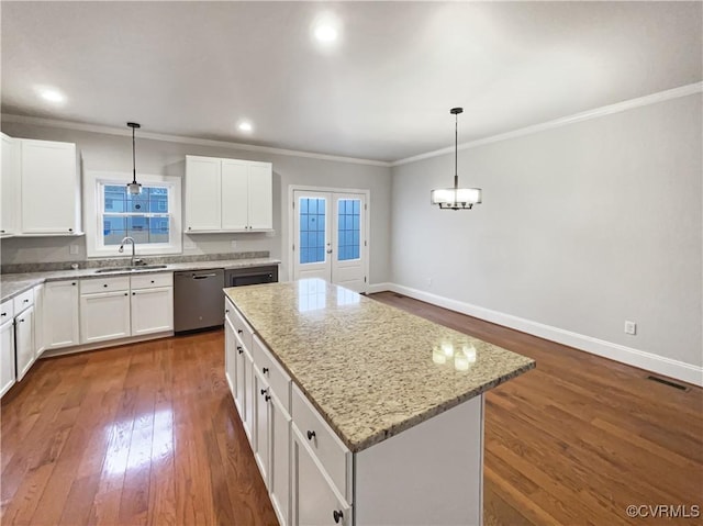 kitchen with baseboards, stainless steel dishwasher, a center island, plenty of natural light, and dark wood finished floors