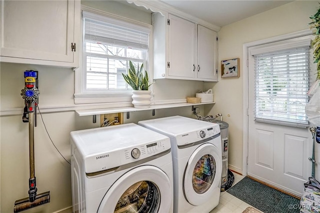 washroom featuring cabinet space and separate washer and dryer