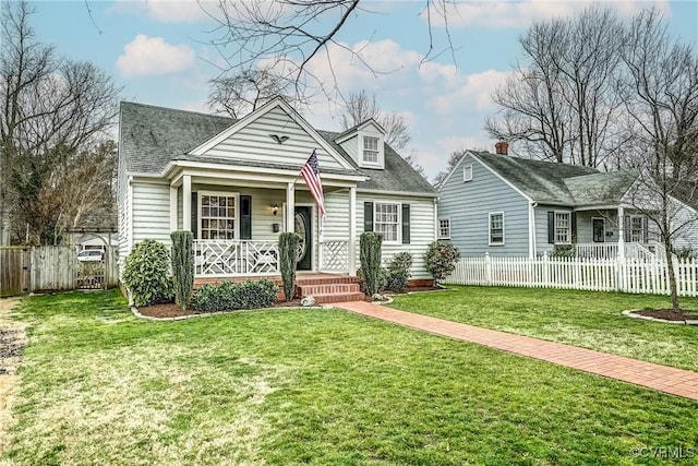 cape cod house featuring covered porch, a front yard, and fence