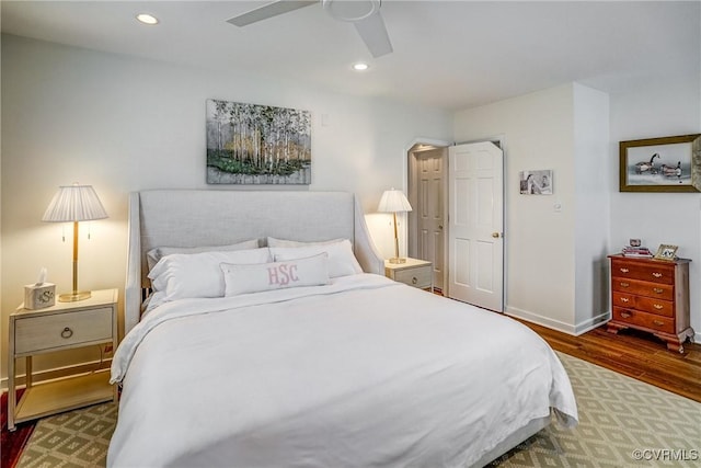 bedroom featuring a ceiling fan, recessed lighting, wood finished floors, and baseboards