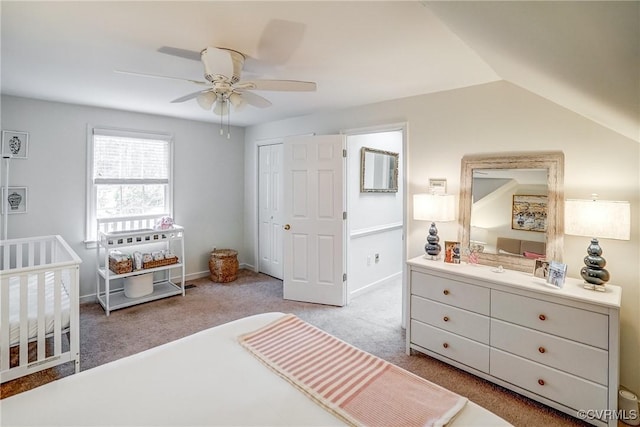 bedroom featuring vaulted ceiling, carpet flooring, baseboards, and a closet