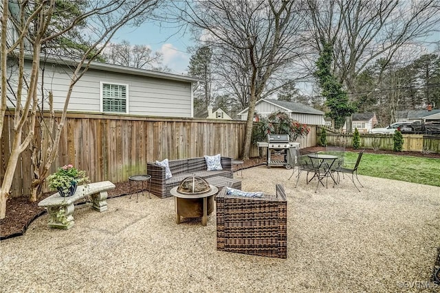 view of patio / terrace with a fire pit, a fenced backyard, and a grill