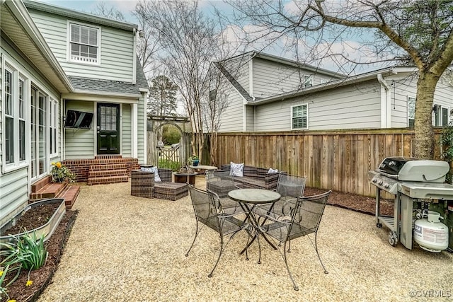 view of patio / terrace featuring entry steps, fence, and a grill