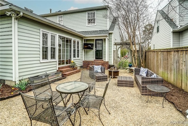 view of patio featuring entry steps, an outdoor fire pit, and fence