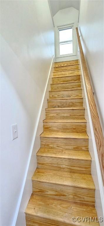 stairway featuring lofted ceiling