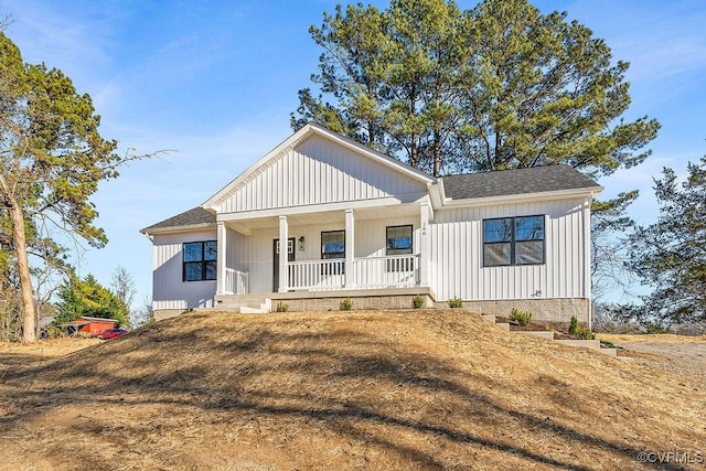 modern farmhouse style home featuring a shingled roof and a porch