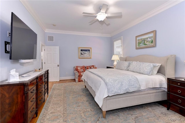 bedroom with light wood-type flooring, baseboards, visible vents, and crown molding