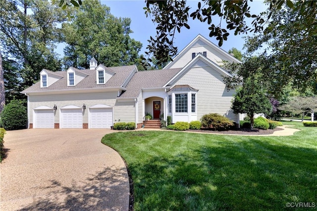 view of front of property featuring an attached garage, roof with shingles, concrete driveway, and a front yard