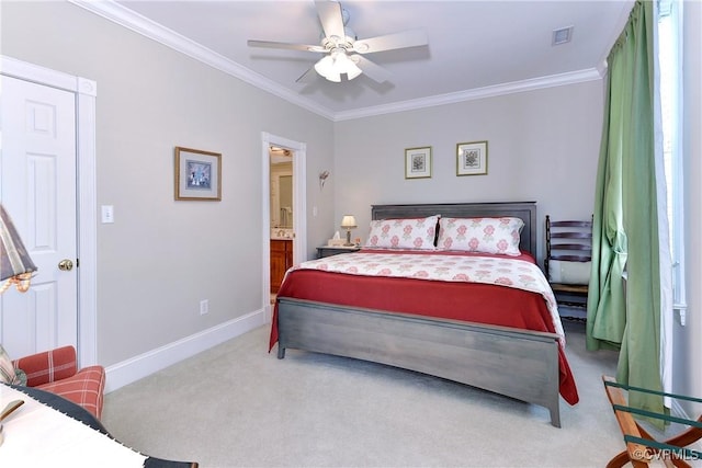 bedroom featuring visible vents, baseboards, ornamental molding, ensuite bathroom, and carpet