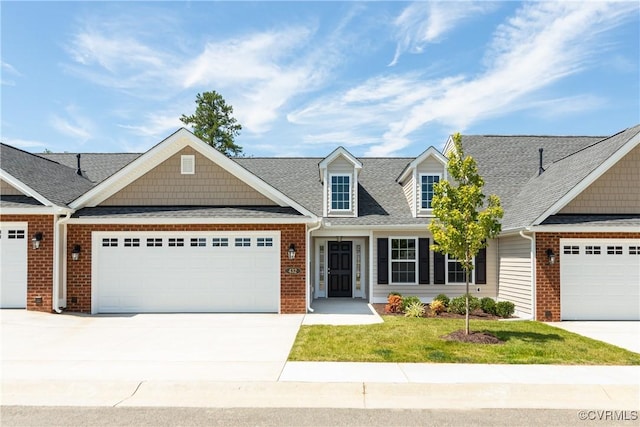 view of front of property featuring brick siding, roof with shingles, concrete driveway, an attached garage, and a front lawn