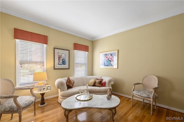 sitting room with crown molding, baseboards, and wood finished floors