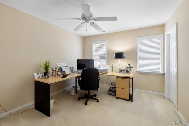 office with baseboards, ceiling fan, visible vents, and light colored carpet