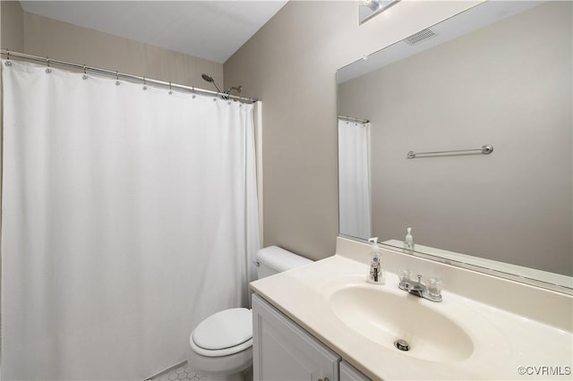 full bath featuring toilet, visible vents, and vanity