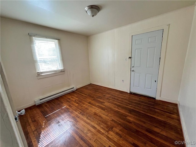 unfurnished room with a baseboard radiator, baseboards, and hardwood / wood-style floors