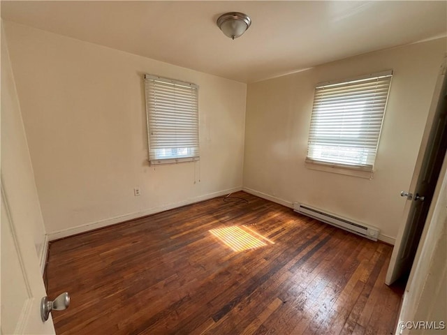 empty room with a baseboard radiator, baseboards, and wood-type flooring