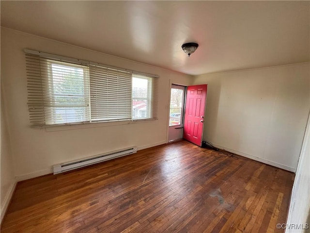 unfurnished room with a baseboard heating unit, wood-type flooring, and baseboards