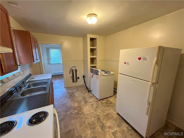 kitchen featuring a baseboard radiator, white appliances, a sink, tasteful backsplash, and brown cabinetry