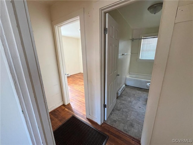 hallway featuring a baseboard radiator and wood finished floors