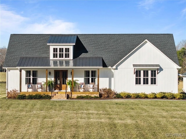 modern inspired farmhouse with a porch, a front yard, and metal roof