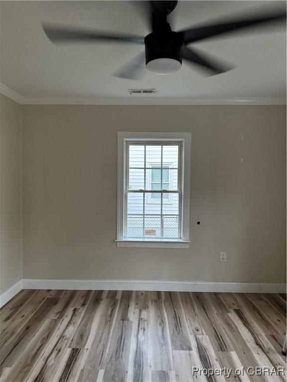 1029 7th St, Petersburg, VA 23803 - empty room with ceiling fan, crown molding, wood finished floors, and baseboards