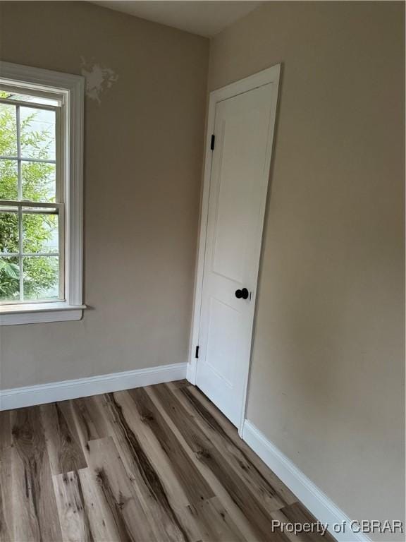1029 7th St, Petersburg, VA 23803 - empty room with wood finished floors and baseboards