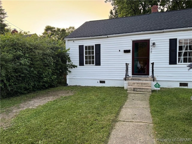 1029 7th St, Petersburg, VA 23803 - view of front facade with crawl space, a front lawn, and roof with shingles