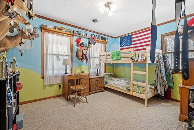 bedroom with baseboards, a textured ceiling, carpet, and crown molding